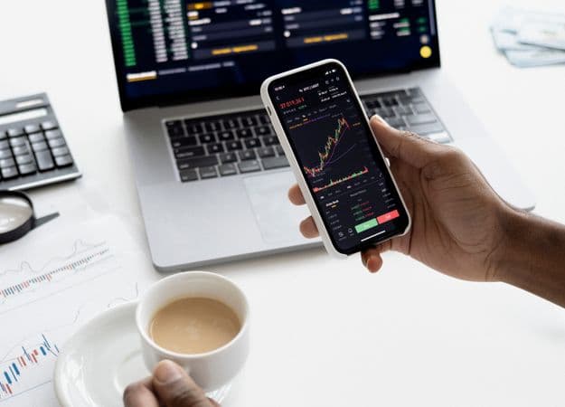Investment chart and calculator on a desk