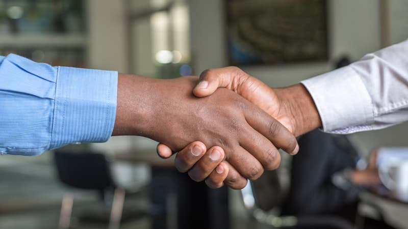 Handshake between colleagues in an office