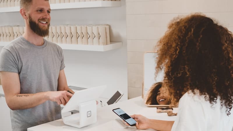 Retail worker at a checkout in a UK shop