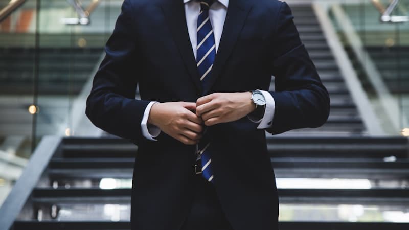 Professional in a suit reviewing work at a desk